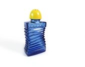 Vintage blue glass bottle with yellow lid, accordion shaker