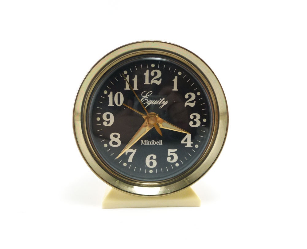 Vintage alarm clock, gold white black with luminous hands