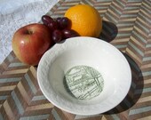 Green and cream vintage dish with embossed surface and transferware horses and sleigh in woodland country winter scene