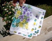 Hanky with fancy stitched hem. White cotton, yellow, purple, teal, green floral decoration. Gift idea for women.