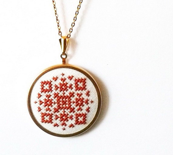 Hand embroidered jewelry amber geometrical ornament on white