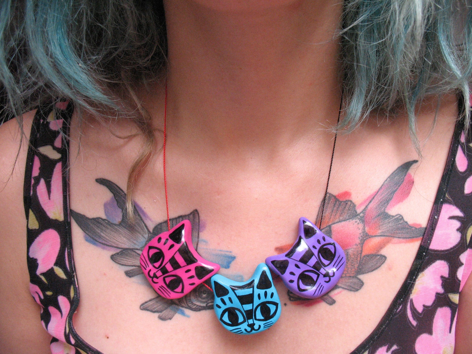 a coloful cats amulet - three rainbow cats