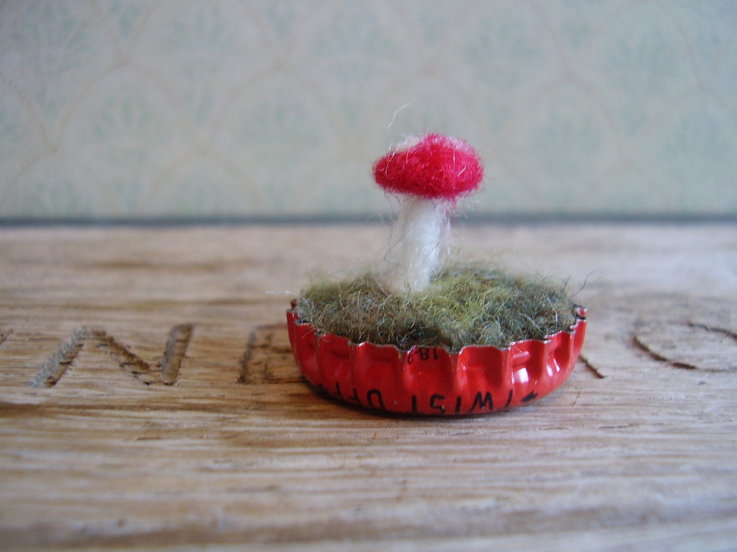 Felted amanita mushroom in a bright red bottlecap
