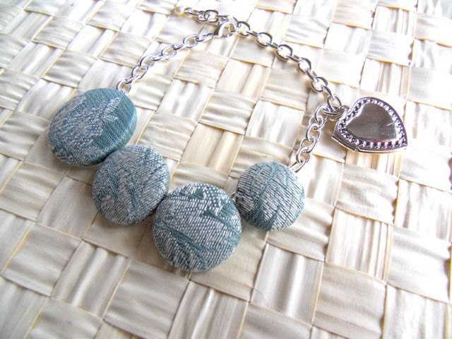 Chain bracelet with fabric buttons and fortune locket