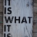 It is what it is sign made from reclaimed plywood