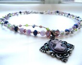 AMETHYST CAMEO: (Lavender Fluorite Rounds, Purple, Silver, and Green Swarovski Crystals, Silver Bugle Beads and a Lavender Cameo Pendant)