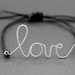 Love Bracelet : Original Silver Handwritten Cursive Wire 'LOVE' Bracelet with Black Cotton Cord, Adjustable Closure, Crimp Beads