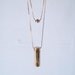 Drie - vintage brass geometric tube and brass bead double necklace