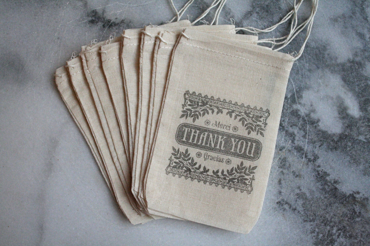 Party favor bags, muslin, 3x5. Set of 25.  Old fashioned Thank You Merci Gracias script in black on natural muslin.