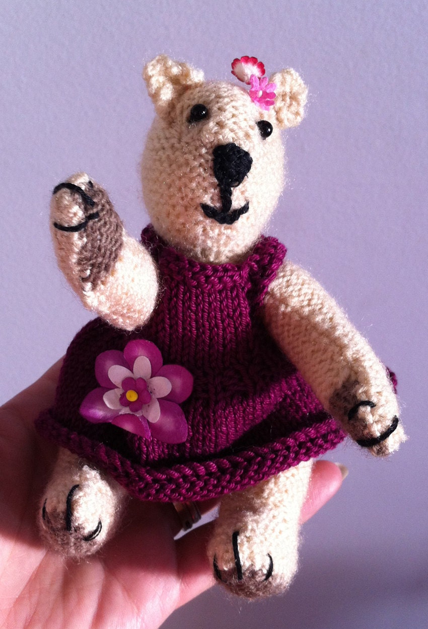 Purple Bear: Knitted toy bear with a flower on her dress and head.
