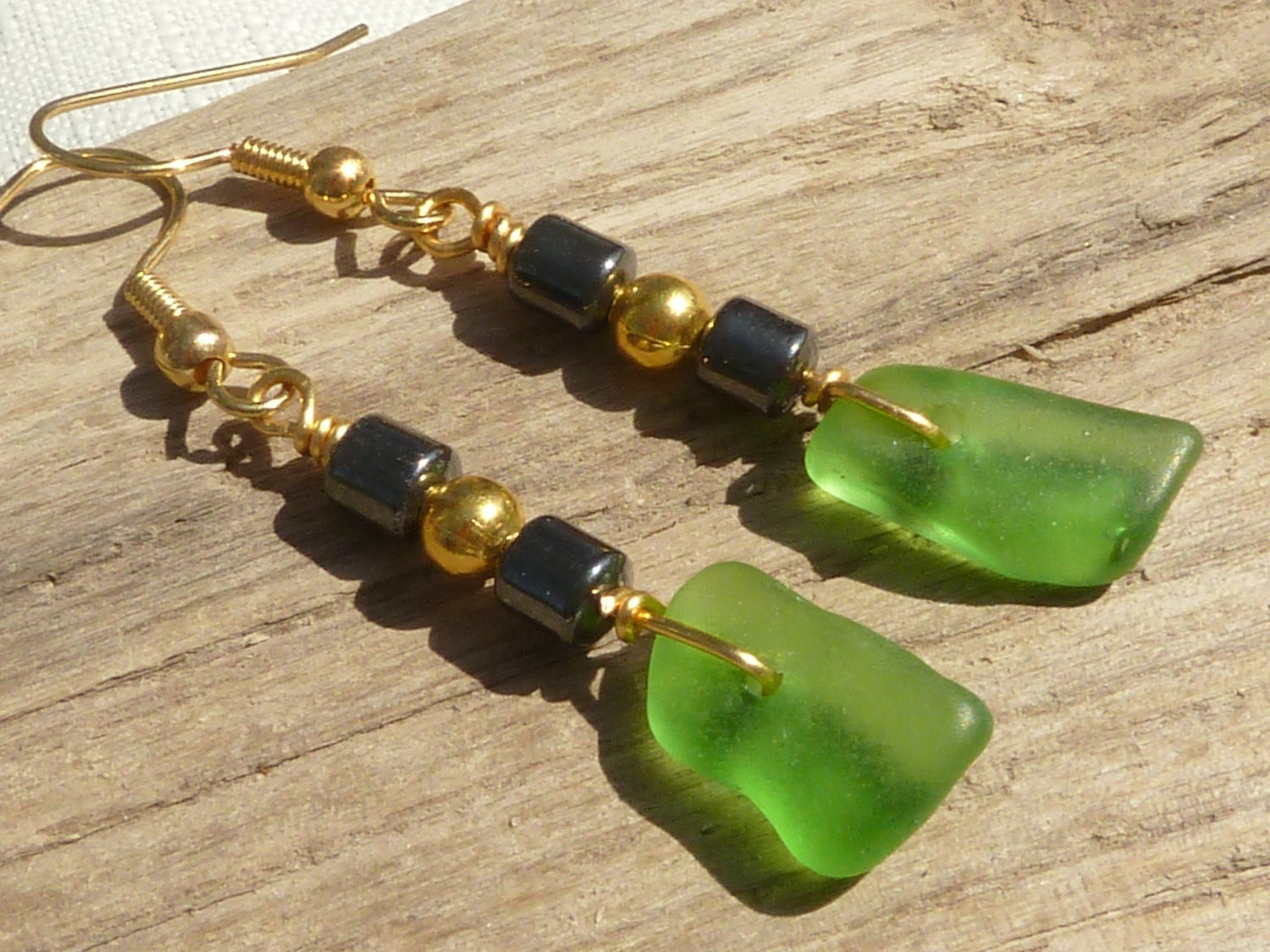 Delicate sea glass earrings with hematite and gold plate beads, ear wires, green - NorthCoastBeachGlass