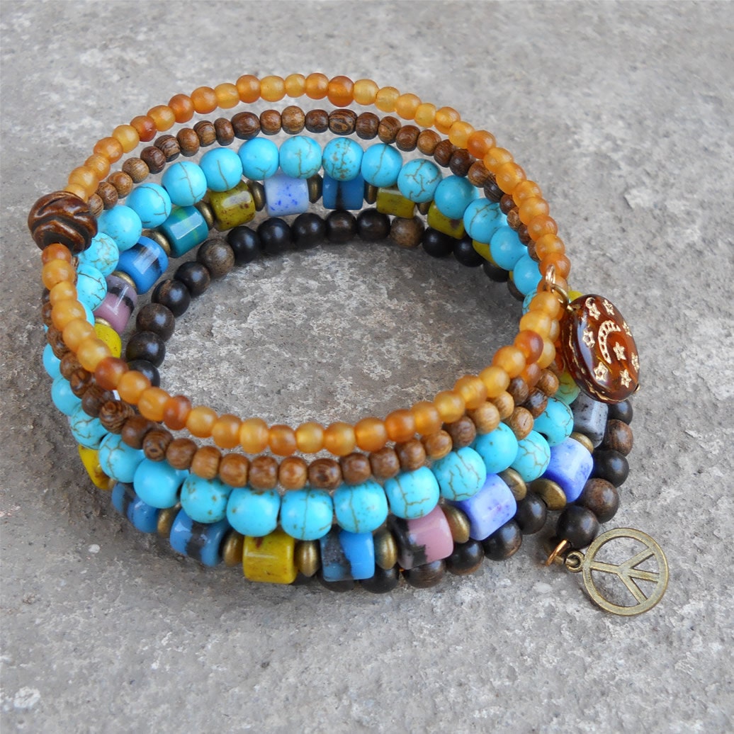 Boho chic - multicolored glass, bone, wood, and genuine ebony, hand painted bead charm, and a peace sign beaded bangle