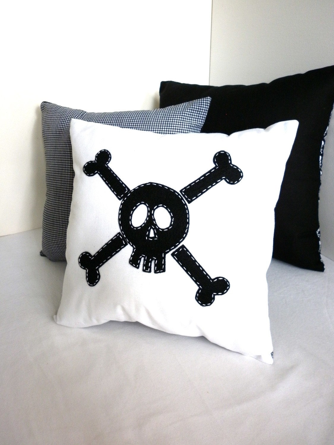 Black Skull and Crossbone cushion cover in small.