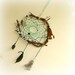 Baby mobile earth art magical dream catcher weaved in 2 shades of green with black pods and spotted feathers.