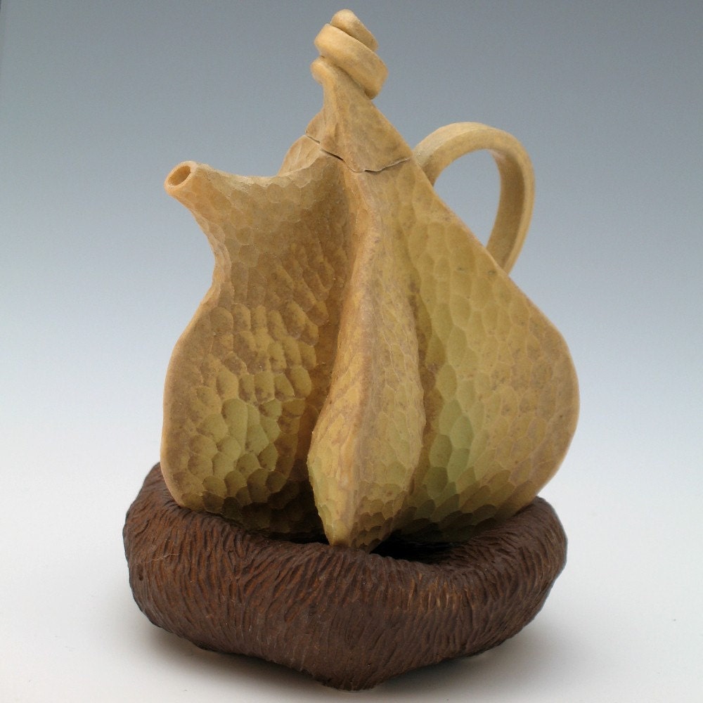 Carved porcelain teapot in tan with brown pillow