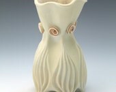Pale yellow porcelain vase with burnt orange rosettes