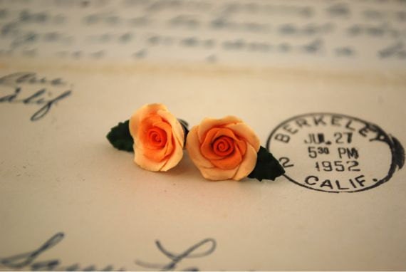 peach-orange-rose earrings in a clay pot