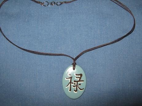 Pendant with Kanji symbol for prosperity in blue and brown