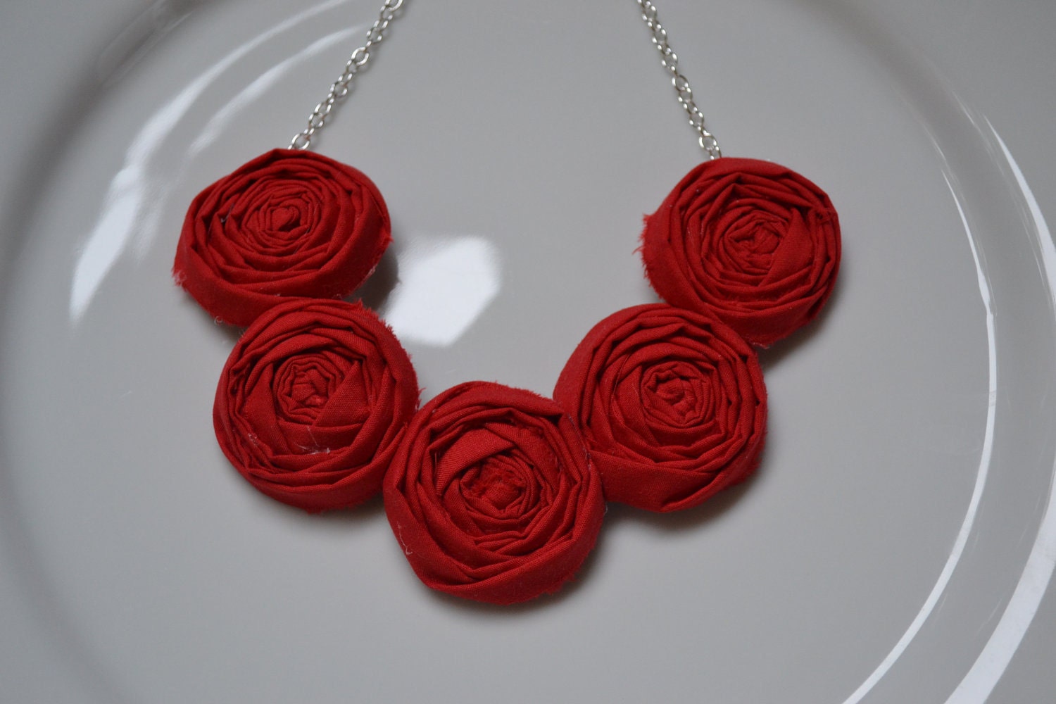 Red fabric rolled rosette necklace