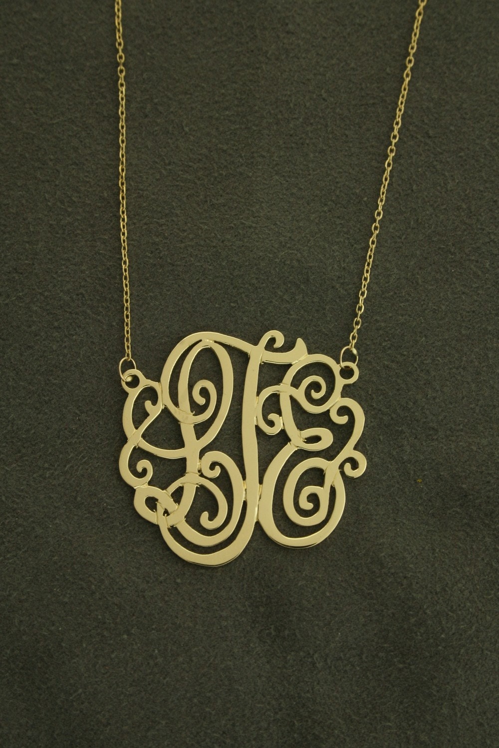 1 1/8" diameter,14k yellow gold monogram on 16" anchor cable chain .
