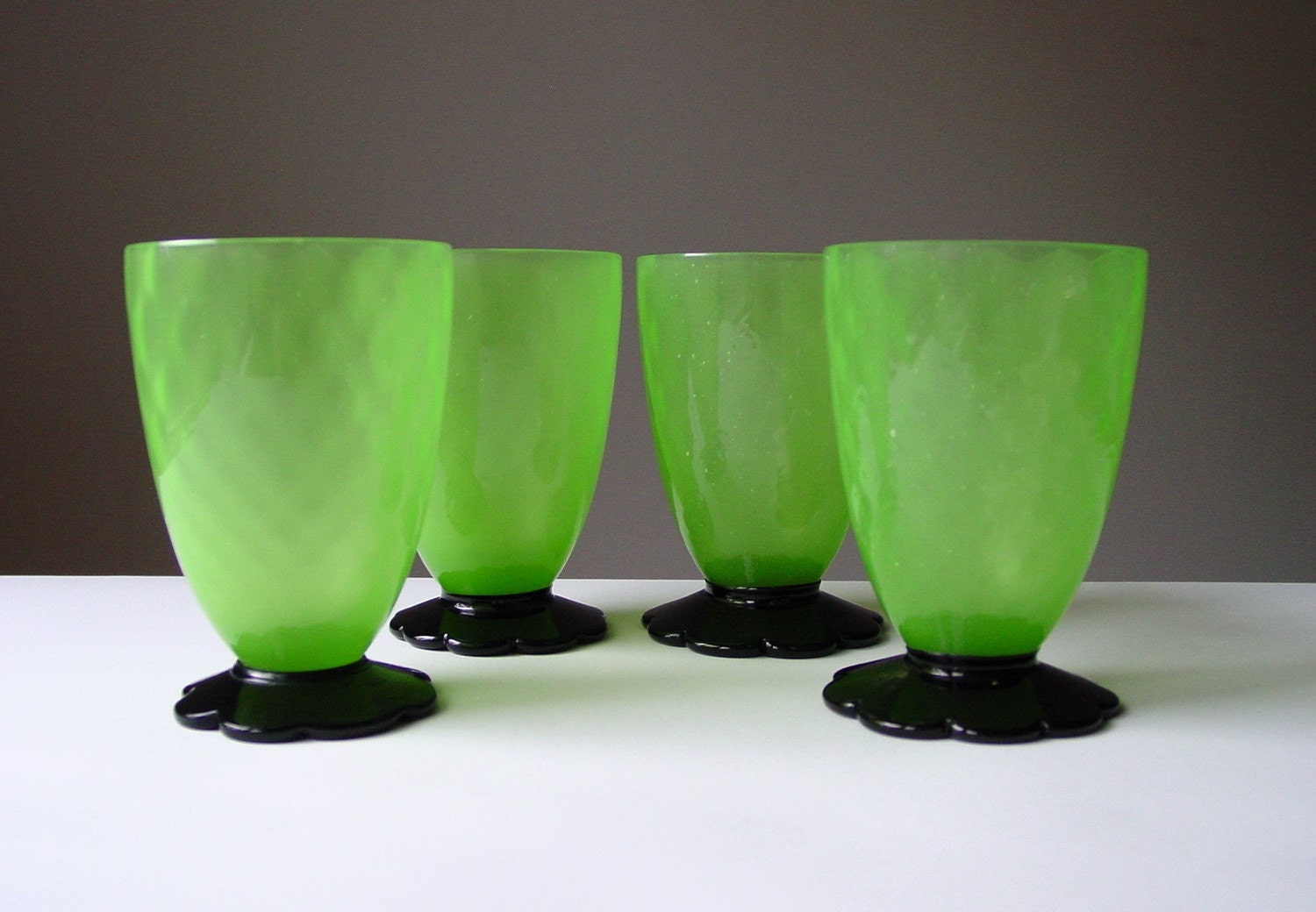 SALE...Grey Gardens Juice Glasses Absinthe Green Depression Glass Black Flower Feet Vaseline