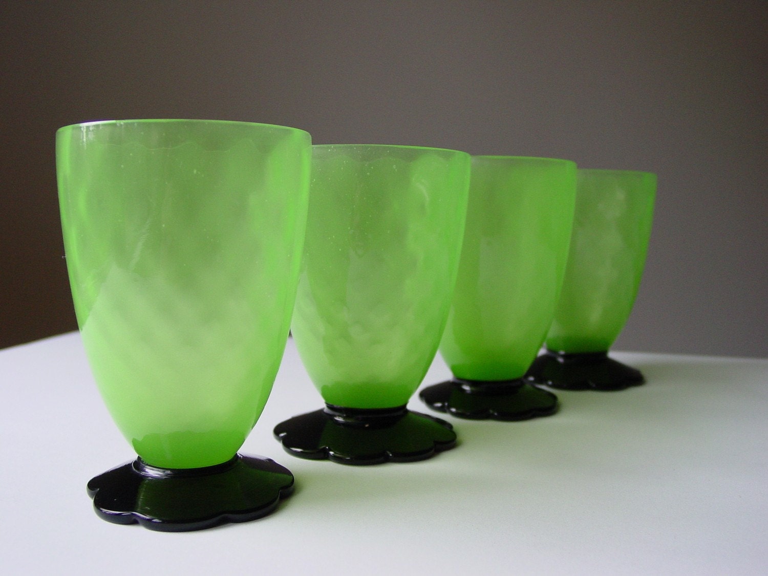 SALE...Grey Gardens Juice Glasses Absinthe Green Depression Glass Black Flower Feet Vaseline