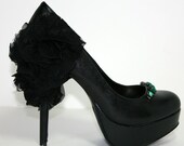 Black high heel pumps with ruffles and emerald stones