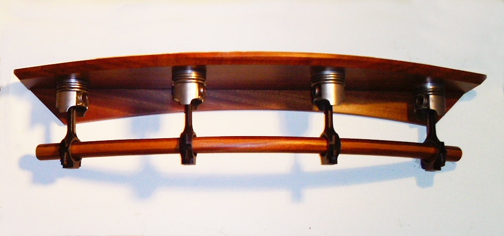 Piston wall shelf