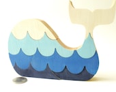 Puzzle whale. Children's game, wood toy, wooden puzzle, whale puzzle with waves.