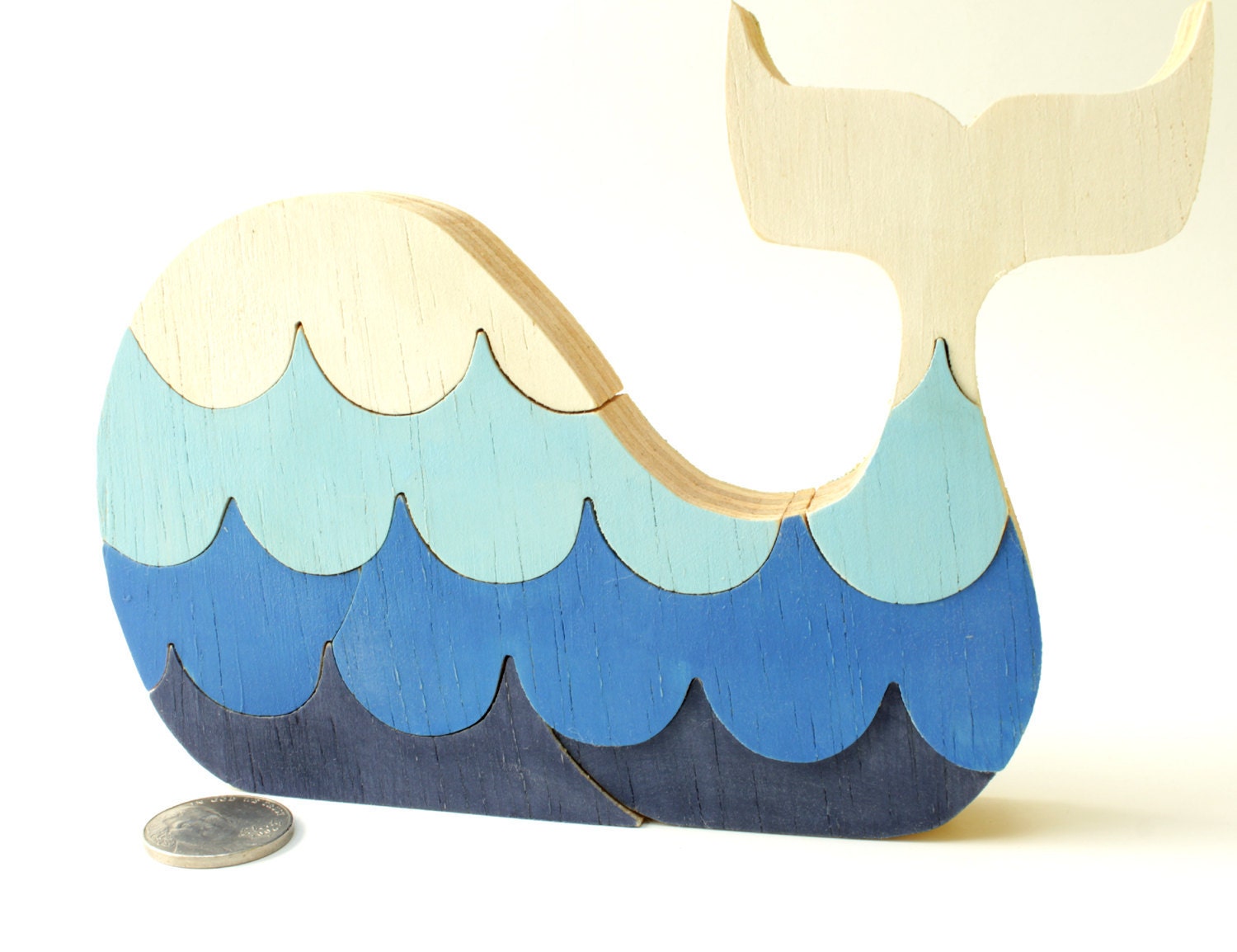 Puzzle whale. Children's game, wood toy, wooden puzzle, whale puzzle with waves.