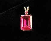 Ruby pendant with ruby accent mounted in silver.