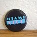 1980s Black Miami Vice Pin Turquoise Lettering