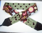 Celery in the Chocolate Garden Camera strap, reversible, 2 expandable pockets with stretchable elastic, celery dot back. Dark brown leather