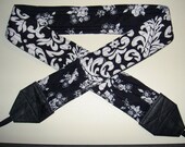 Rosy Posy Damask in blacks camera strap, reversible, 2 expandable pockets with stretchable elastic.