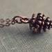 petite pine cone necklace.