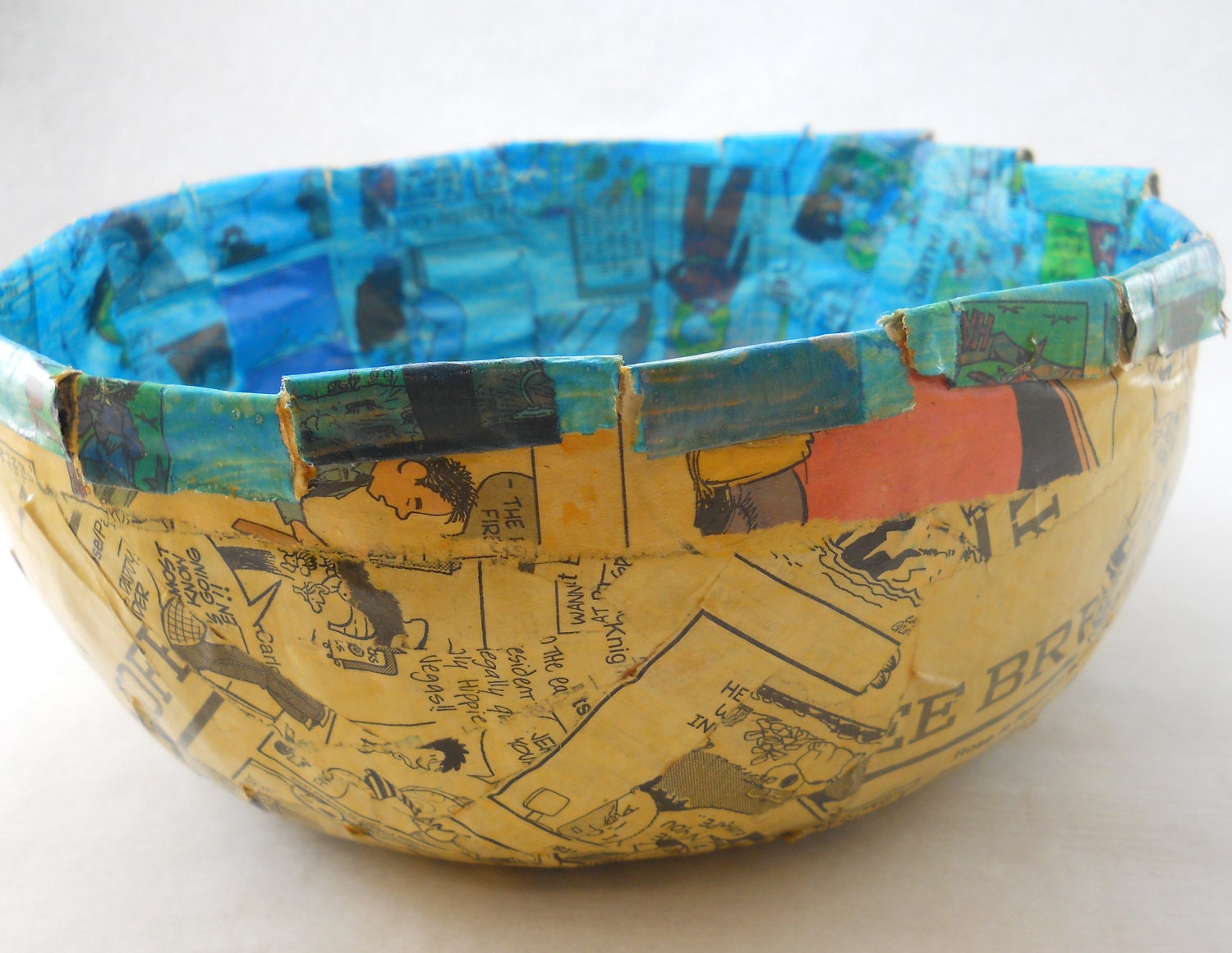 papier mache bowl, comic strips, turquoise and yellowed newspaper