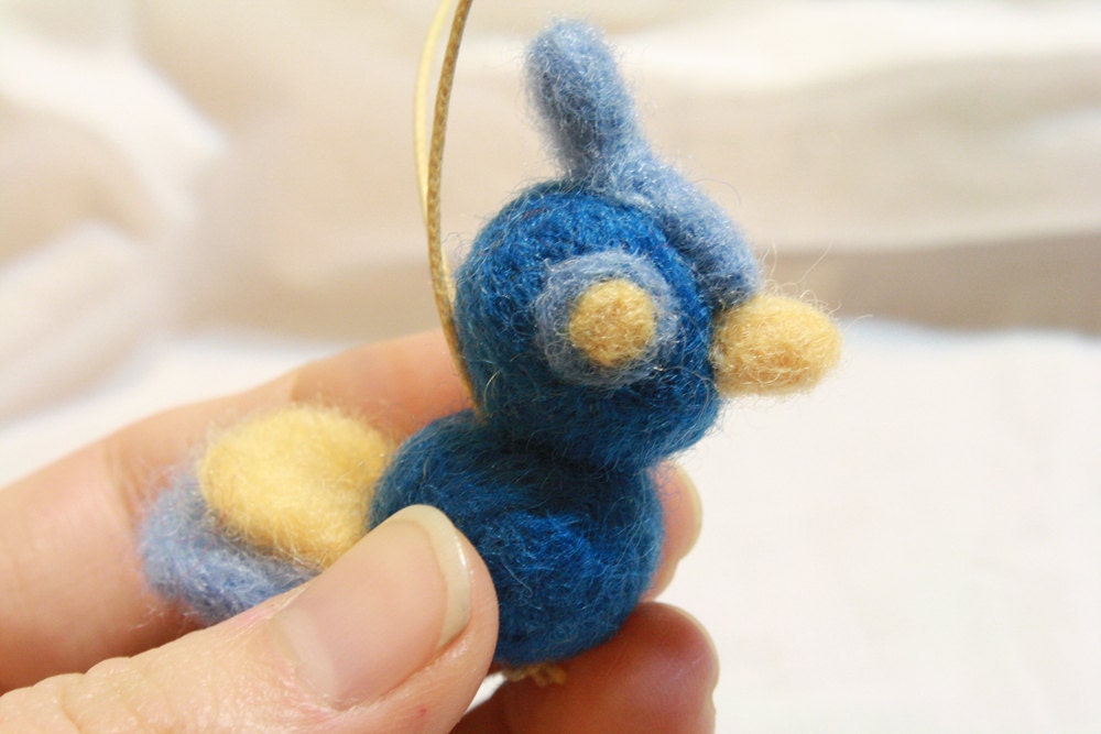 wide-eyed blue and yellow needle felted bird ornament