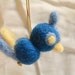wide-eyed blue and yellow needle felted bird ornament