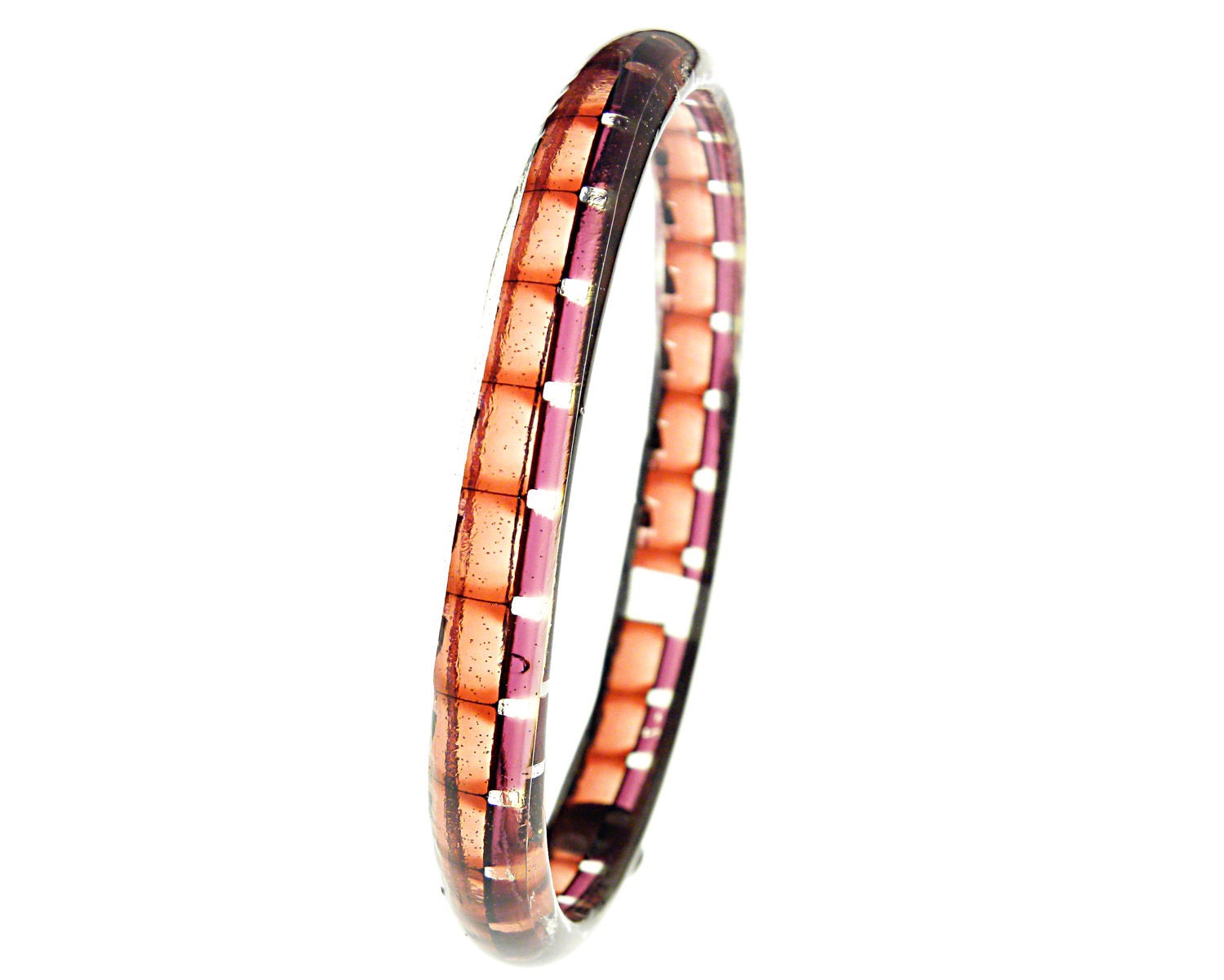 resin and filmstrip spacer bracelet . Super 8 size . vintage pinkish orange purple film edge