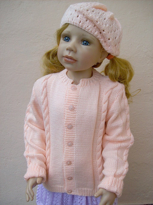 Knitted child sweater in peach colour