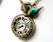 Steampunk Pocket Watch Necklace - Bird Charm and Blue Flower Bead on an Antique Brass Pocket Watch Necklace- Steampunk Mockingjay Necklace