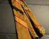 Ochre red striped necktie with black / dark blue embroidery adornment