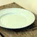 Mint green enamelware dinner plate with blue rim