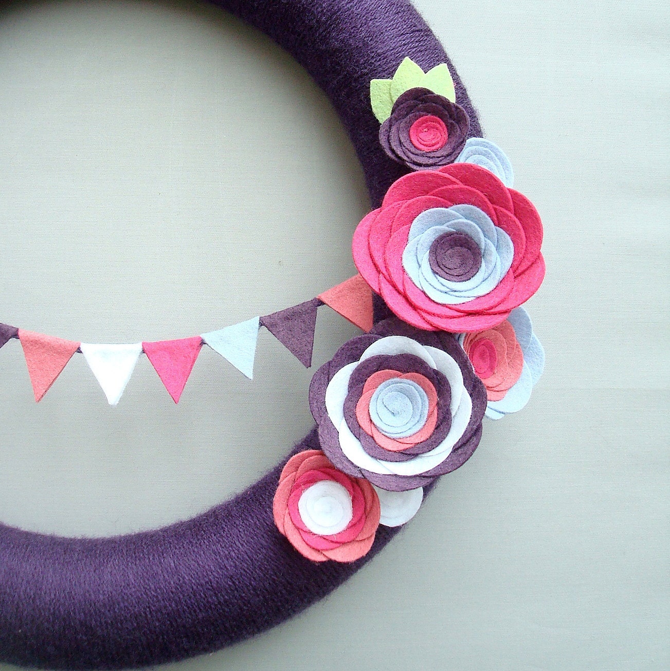 Purple Yarn Wreath. Pink, fuchsia, light blue and white felt flowers and felt bunting. Great for girl's birthday party. 14" door wreath.