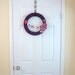 Purple Yarn Wreath. Pink, fuchsia, light blue and white felt flowers and felt bunting. Great for girl's birthday party. 14" door wreath.