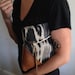 T R A V E L collection Leather and cotton clutch, cream color