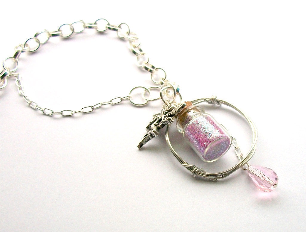 Fairy tale necklace- miniature bottle necklace filled with glitter dust and decorated with a fairy charm and a pink Swarovski crystal