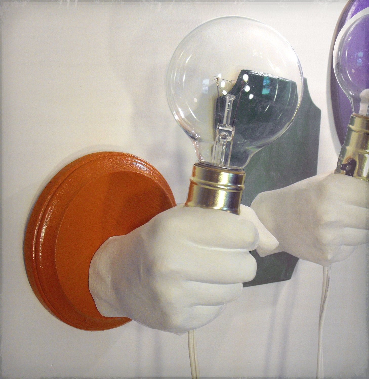 Hand Holding Bulb Wall Lamp (Orange)
