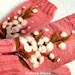 Pink fingerless gloves with felted flower.