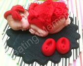 Fondant Baby in a Red Oufit and Black Base